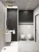 Moderner Badezimmerbereich mit einer runden Regenbrause in Brushed Gold von Ideal Standard, Waschbecken mit goldenen Armaturen und Toilettenbereich an einer grauen Wand.